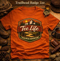 Tee Life Trailhead Badge Tee - orange t-shirt with Trailhead Adventure badge graphic